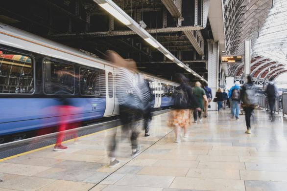 Rail passengers walking along platform