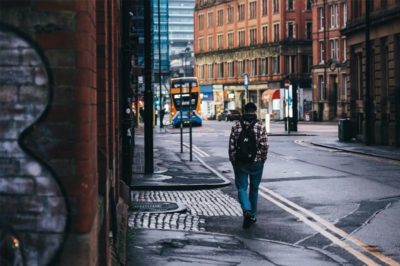Man walking along street in Manchester