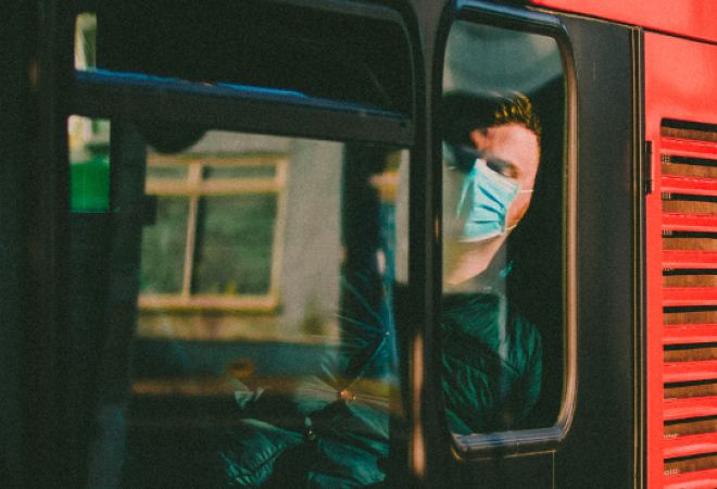 Man in a mask on a bus