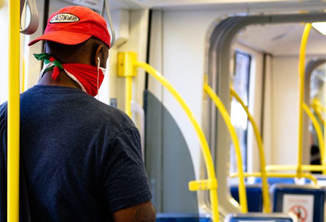 Man with face mask inside a train alone