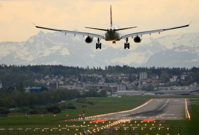 White biplane landing at airport
