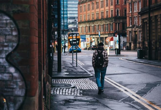 Man walking along street in Manchester
